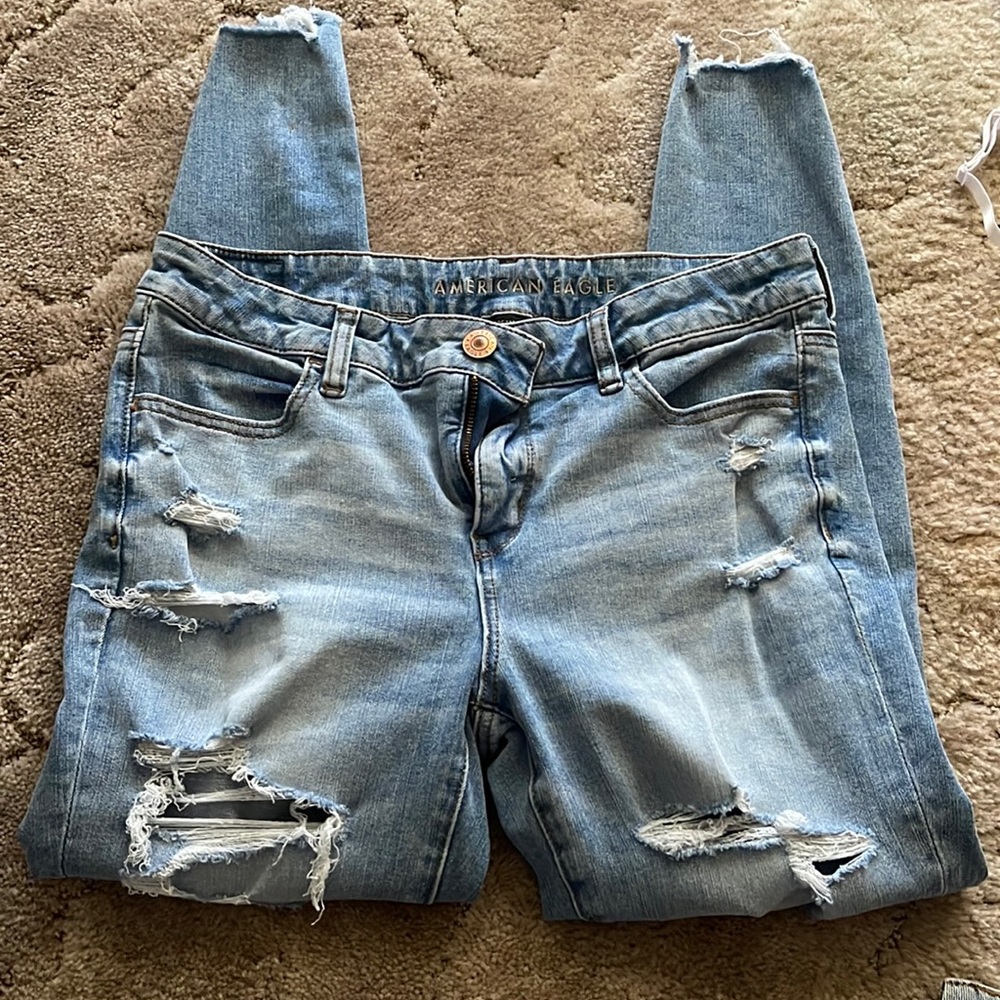 American Eagle Jeggings. Light blue in color with holes down both legs.